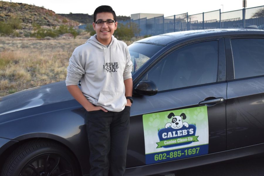 Caleb Bautista, junior, stands near his business’ advertisement that he proudly displays on his car.