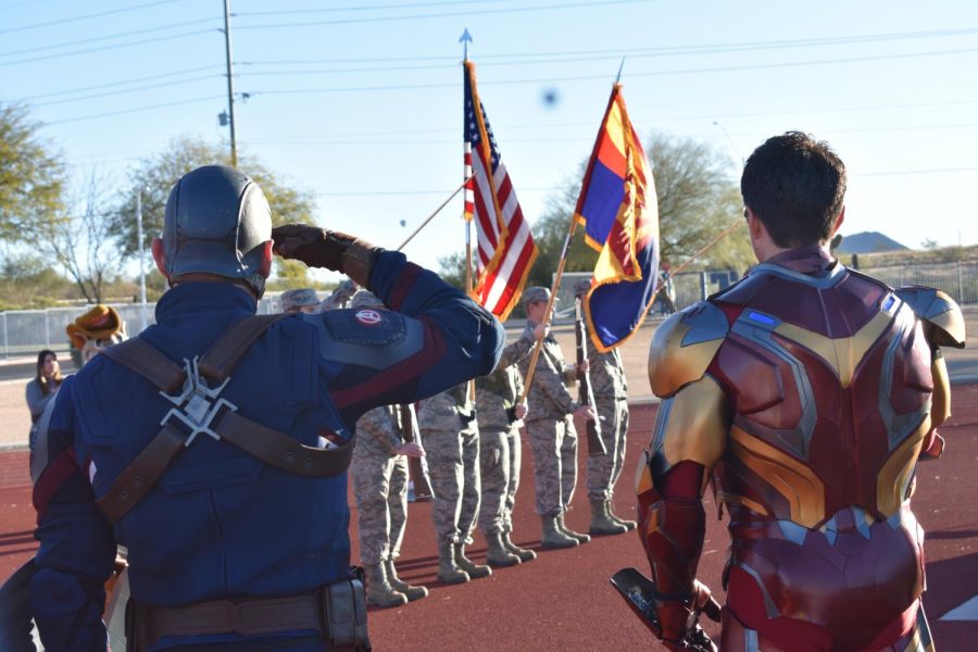 Captain America and Ironman stand for the national anthem before the 10K rcae begins.