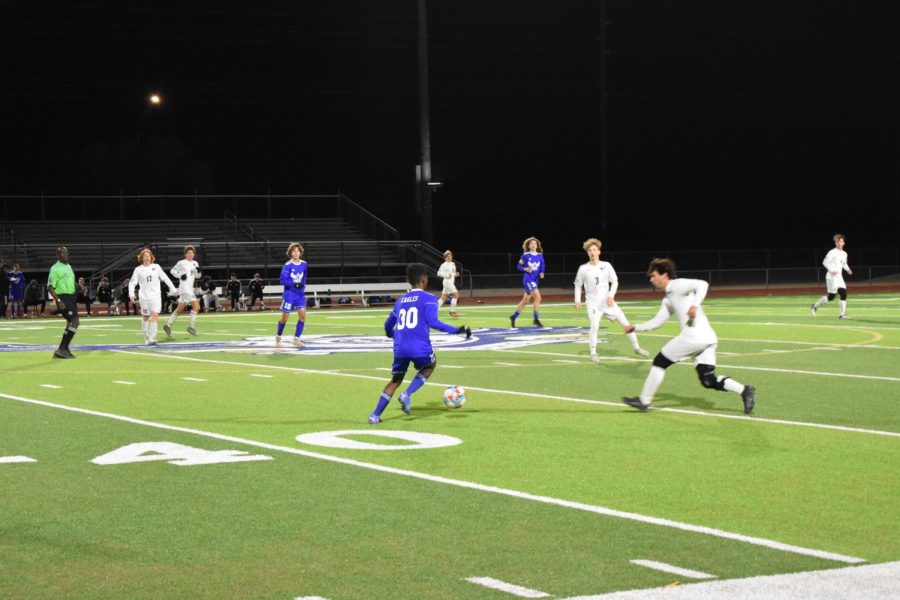 Boys soccer dribbles up the field at a game against Pinnacle.
