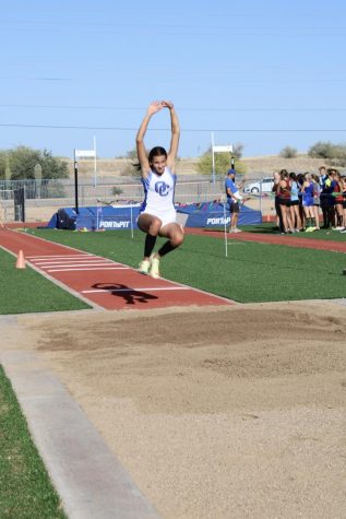 Chandler Miller, junior, competes at long jump during the District Meet.