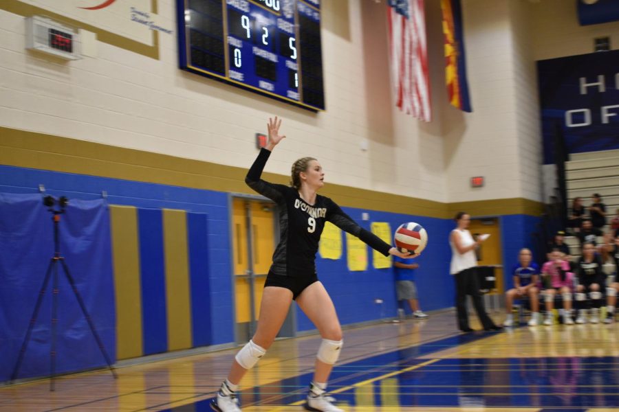 Paige+Hoeder%2C+senior%2C+powerfully+serves+during+a+home+game.