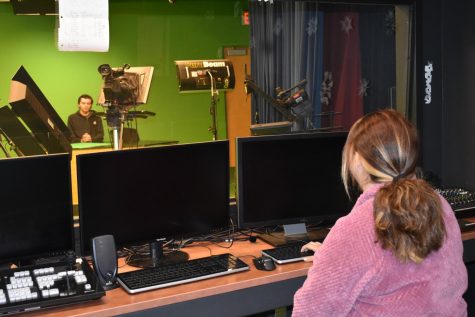 Evan Day (back), sophomore, and Caroline Macias (front), senior,
record the morning announcements in the Media Productions studio.