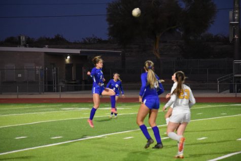 Kinley Clifford, senior, delivers a strong header for her team.
