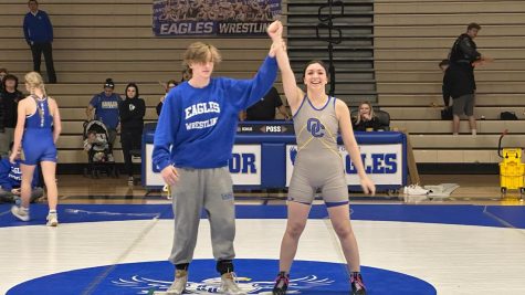 Mia Martinez, senior getting her hand raised after winning a match. 
