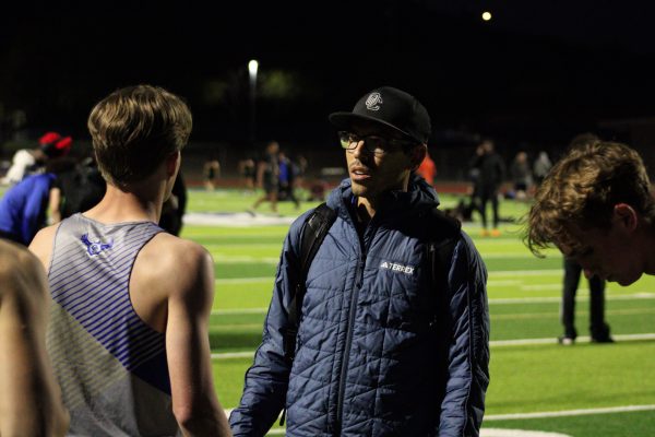 Kellen Chavez advises a runner on the track team on how to be successful in his event.