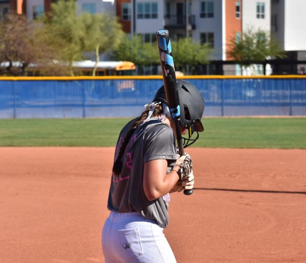 Charleigh Schuettler, junior, lines up to bat during a game. 