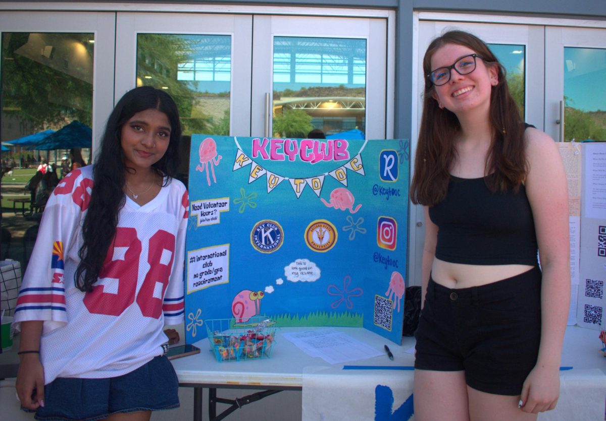 Shloka Nair, junior (left), and Julia Steere, junior (right), promote Kley Club and Club Rush