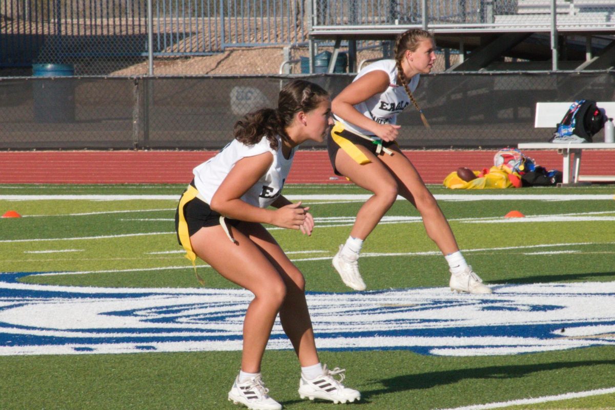 Lauren Silhol (Front), senior and Becky Currence (Back), junior, drop back to cover the receivers.