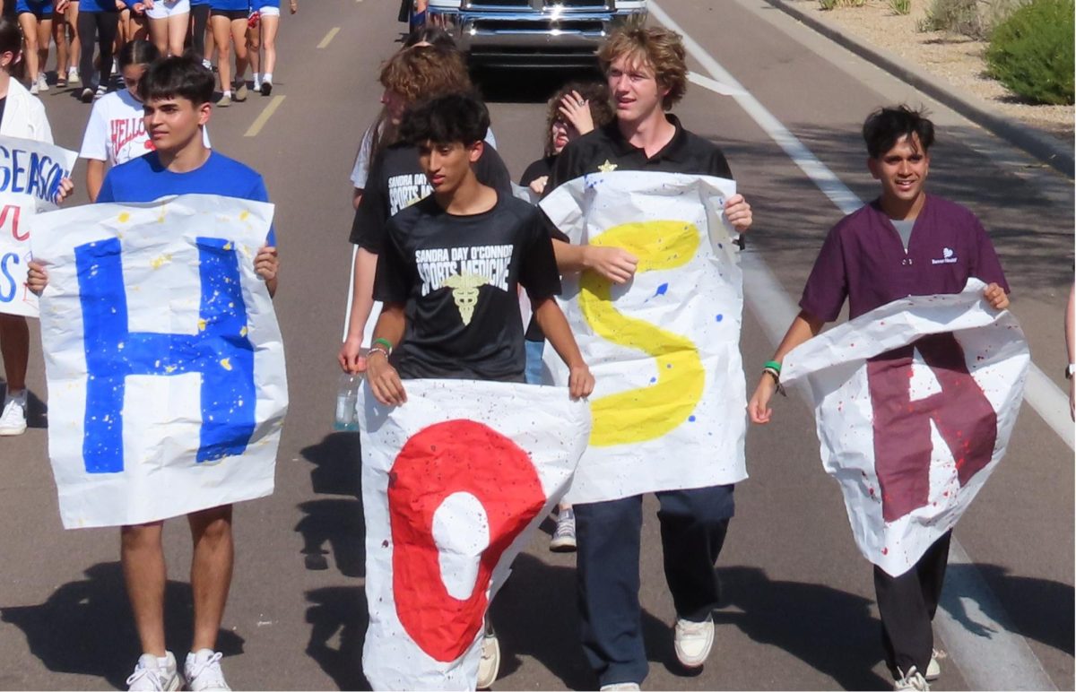 Andrew Hirani (senior), Jayneal Patel (senior), Ryan Morris (senior), Krish  Patel (senior), walk in the Homecoming parade. 