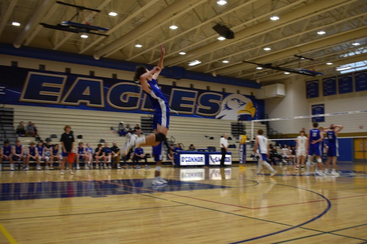 Noah Kaoni goes back to serve.