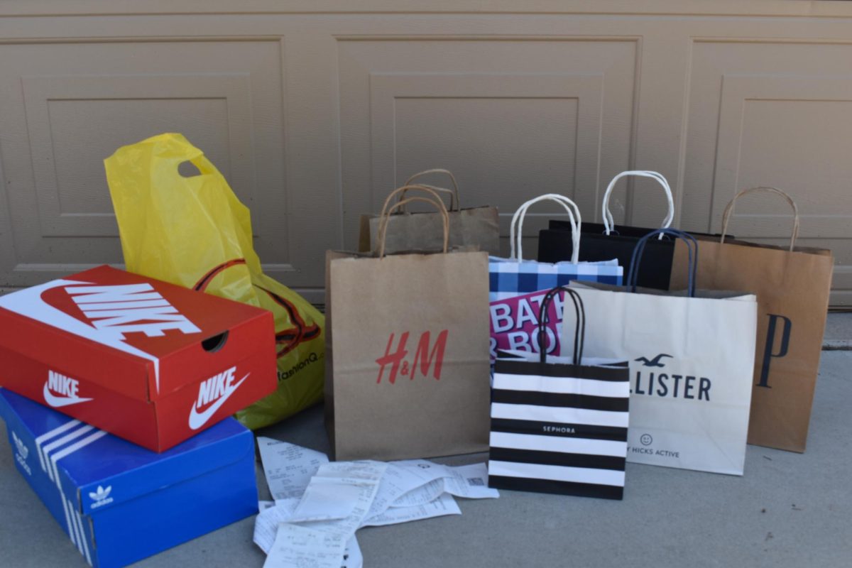 Numerous shopping bags are lined up, displaying overconsumption.