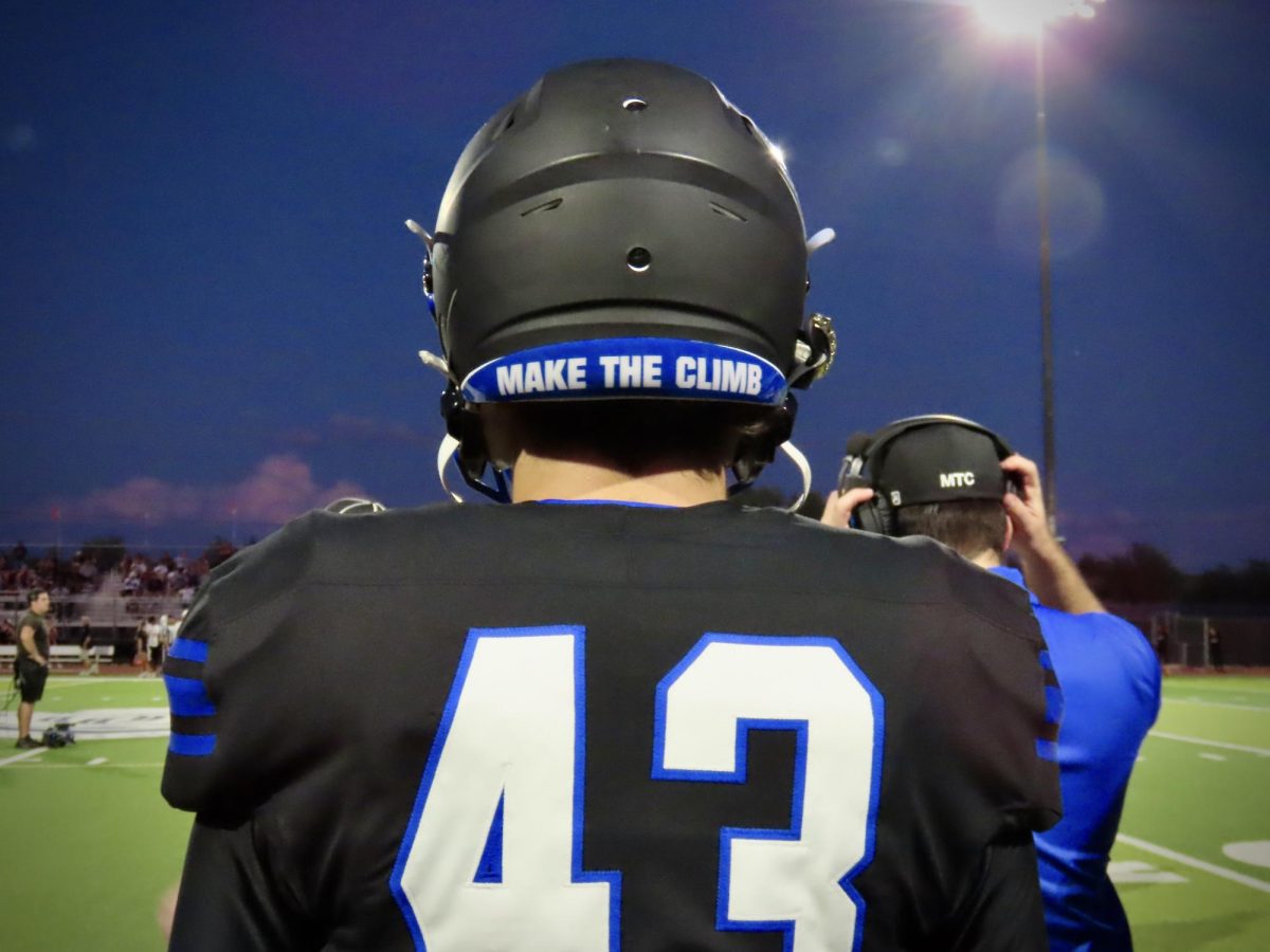 Aiden Evans, junior, stands ready to make the climb.