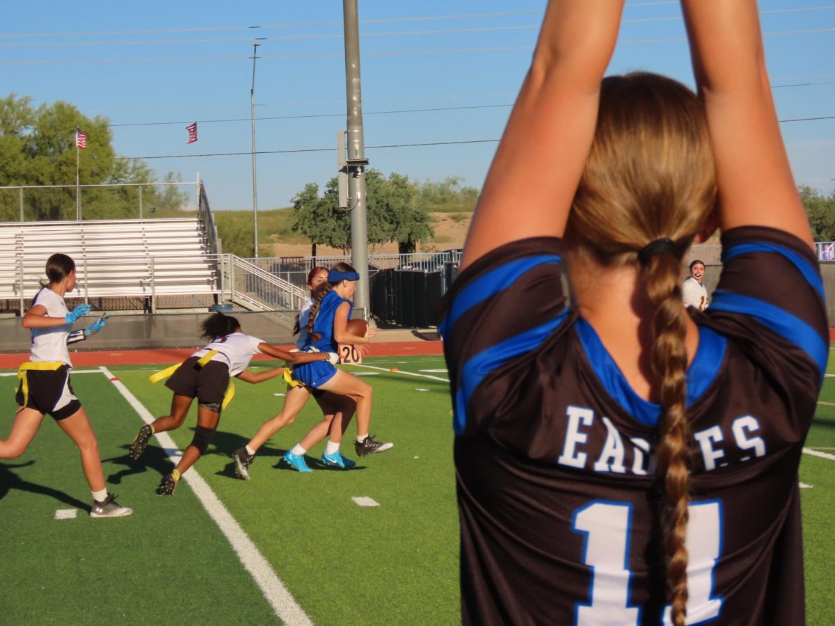 The flag football team demonstrates school spirit as one of their players runs for a touchdown. 