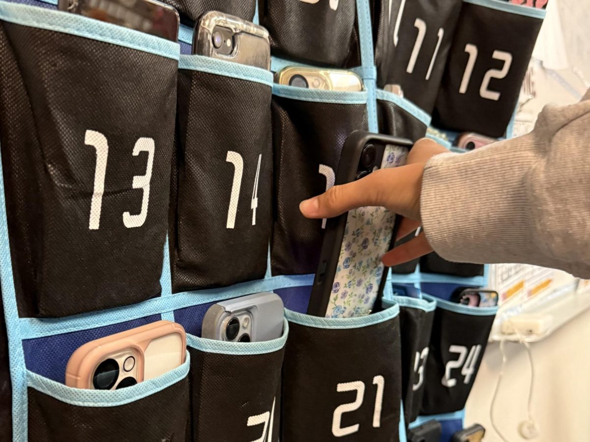 Freshman Nicole Lugoj puts her cellphone in phone jail during ELA period
