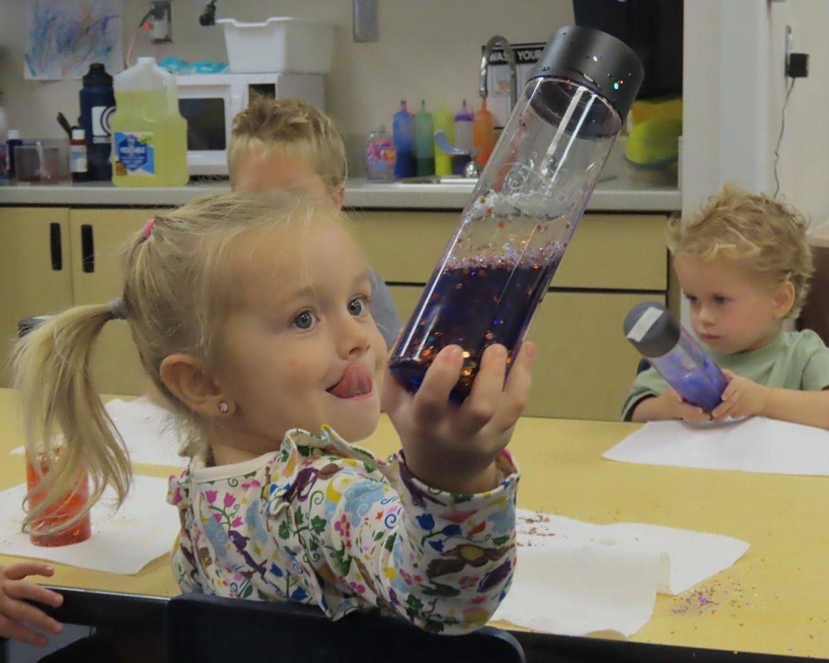 Preschool student works on her craft.