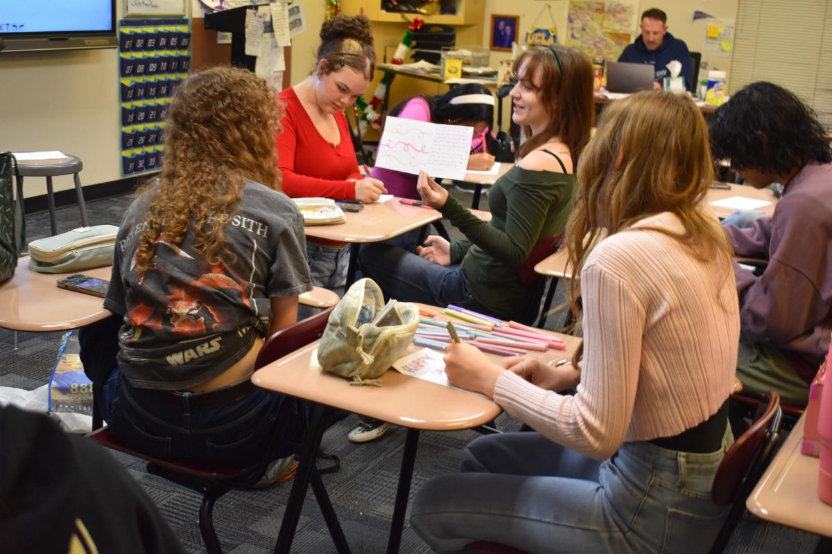 Members of BC2M make posters during a morning meeting.