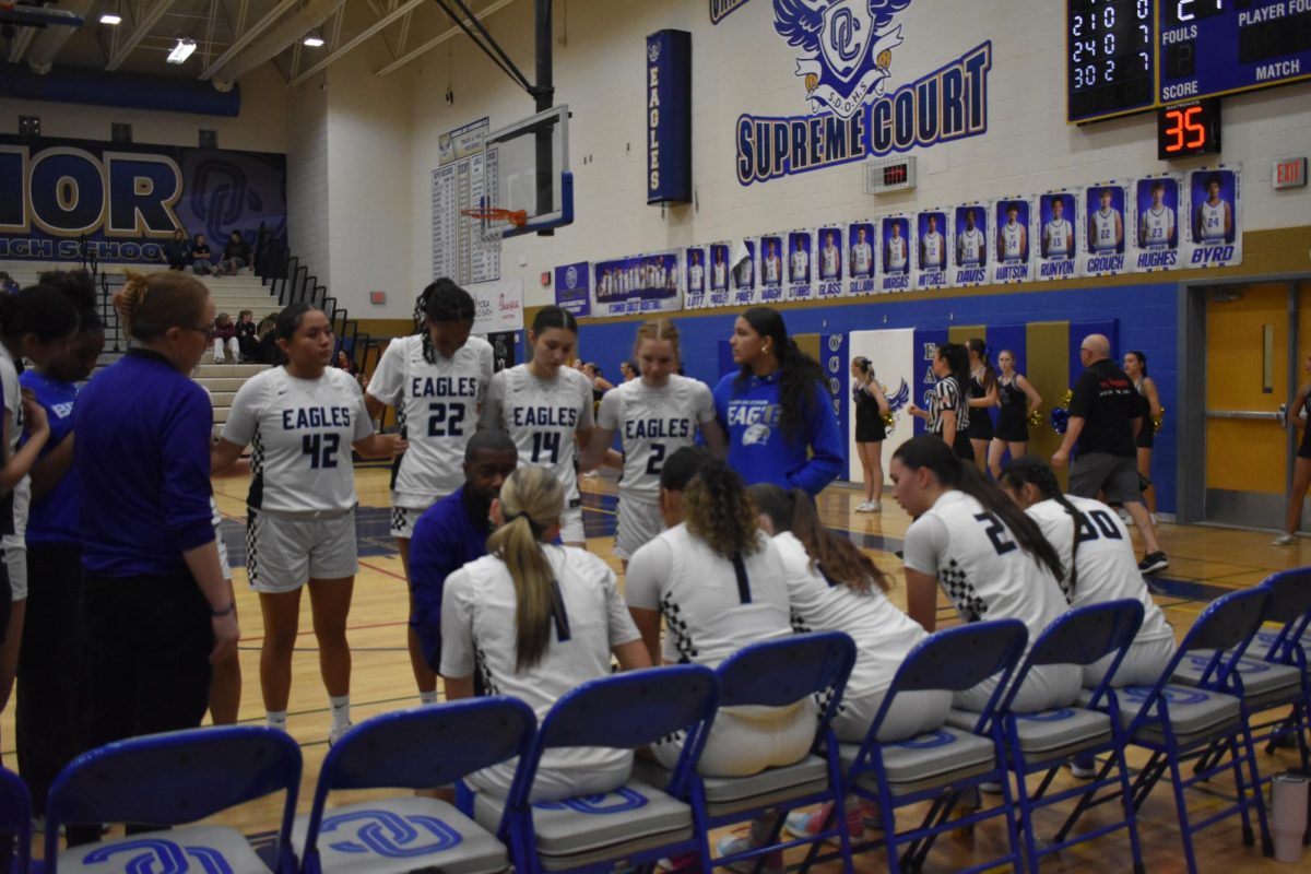 OHS girls basketball gather for a team huddle.