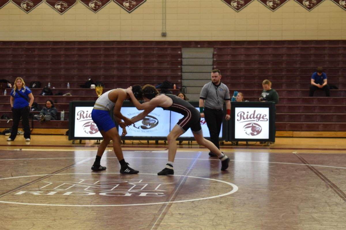 Jonathan Klitzke, sophomore, engages in a match with a Mountain Ridge wrestler.