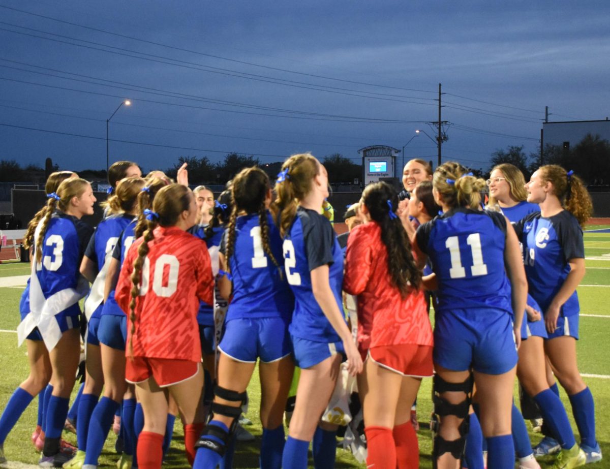 OHS varsity girls soccer huddles together during their senior night. 