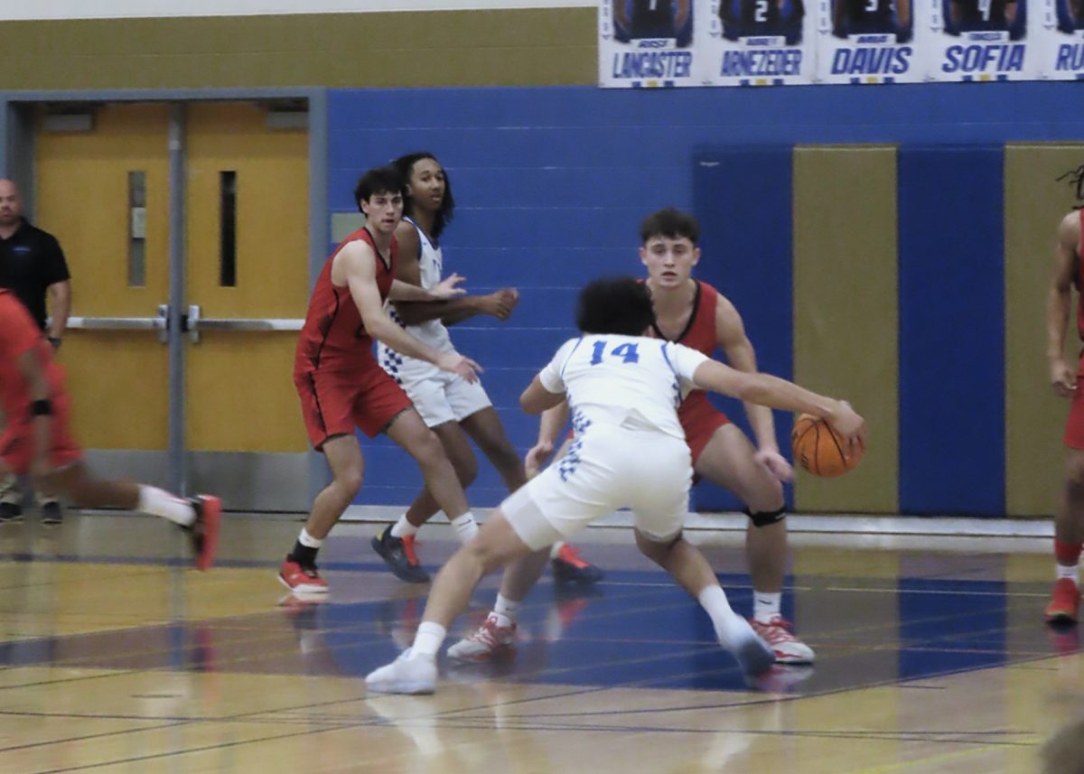 Colton Watson, senior, attempts to score on the competition.  