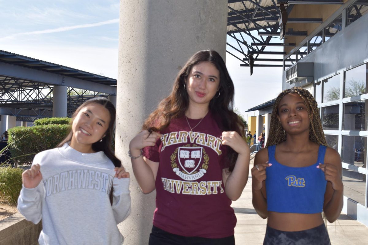 Nicole Eom, senior, Elizabeth Young, senior, and Olivia Bowen, senior (left to right) display their future schools and higher education.