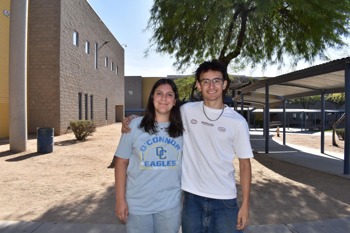 Mia Lopez, sophomore, smiles for photo with her brother Michael Lopez, senior.