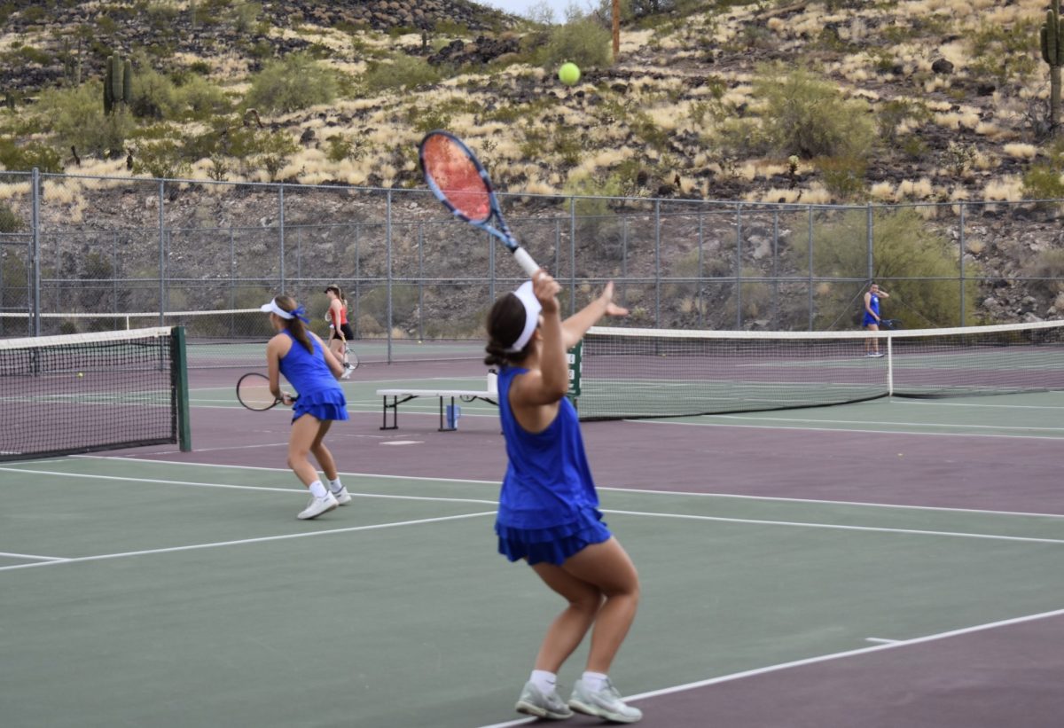 Mihaela Ursu, junior, serves the ball during her doubles match against Chaparral. 
