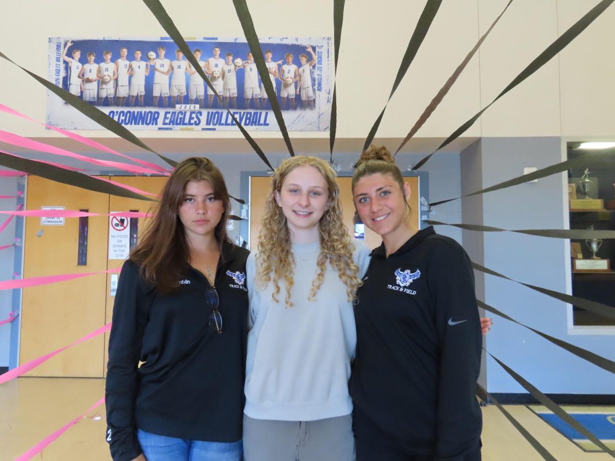(Left to right) Early graduates Morgan Hamblin, Grace Schlicklin, and Morgan Spector attend their last school assembly as juniors.