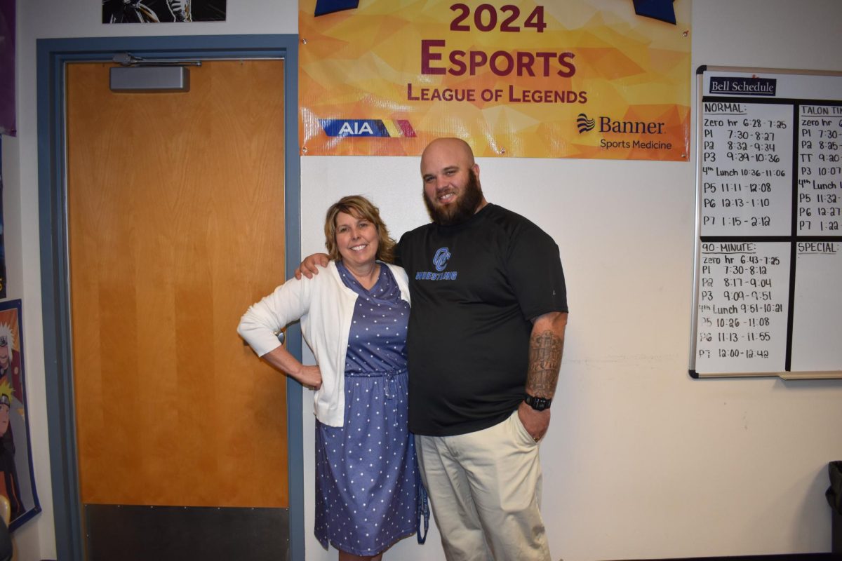 Rhona Cunningham, english teacher, posing with Tom Devito, former student and current teacher.