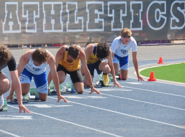 OHS athletes prepare for their 300 meter hurdles race.